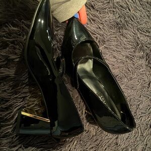 Black high heels with a gold stem